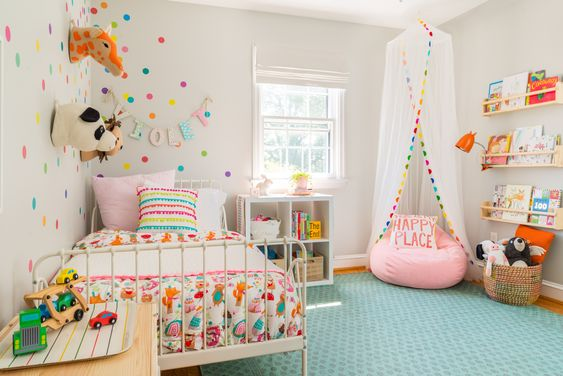 Small kid's bedroom design with colorful polka dots and a canopy over a beanbag.