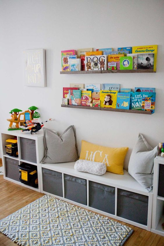 Storage shelves with children's books and a bench with cubbies.